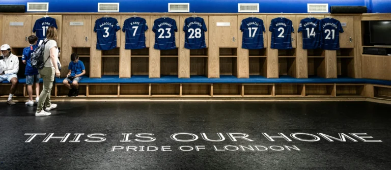 Inside the official Chelsea FC dressing room at Stamford Bridge, showcasing the club's heritage and environment for its 2026 official partners like BingX