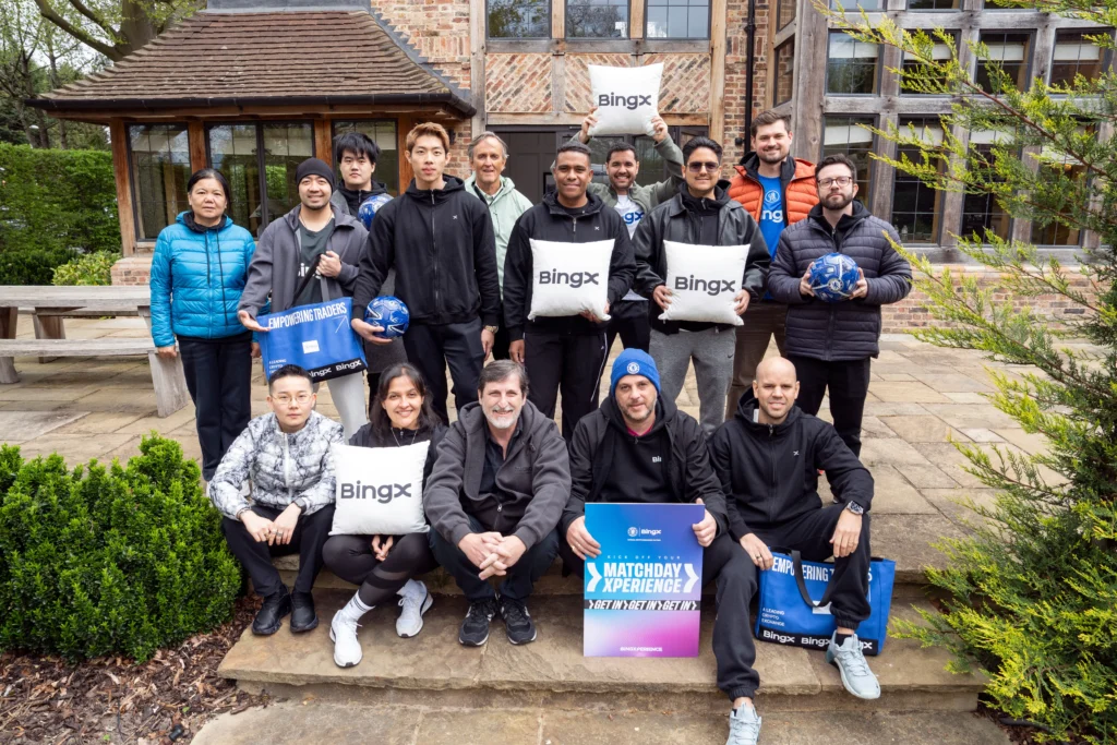 BingX VIP group at Cobham holding BingX cushions Chelsea footballs Matchday Xperience sign