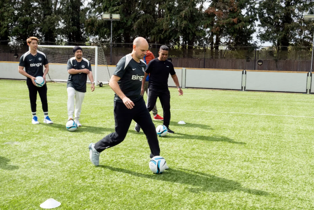 BingX VIPs on Cobham training pitch doing drills in BingX kit 
